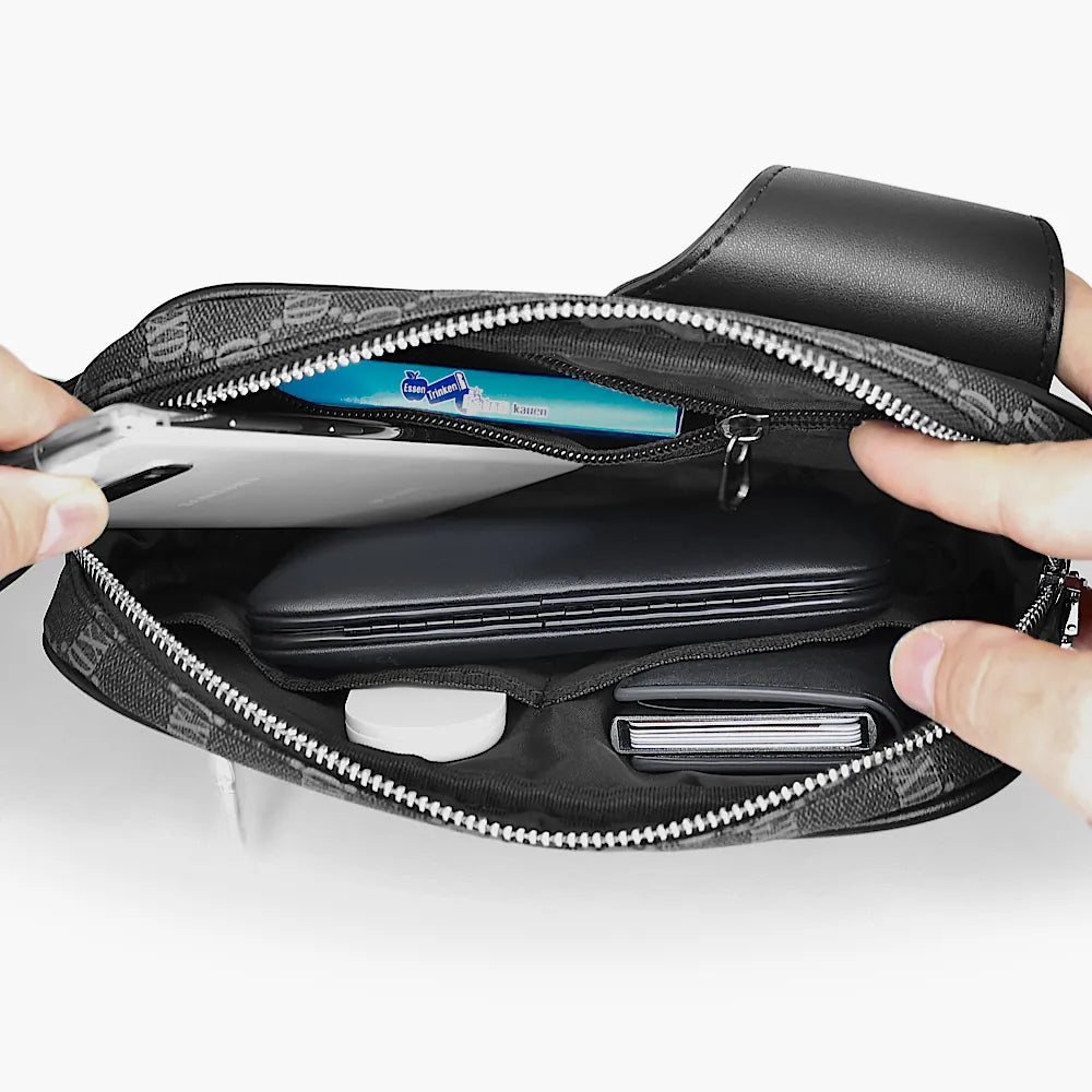 Innenansicht einer Avenue Sling Bag, die verschiedene Gegenstände wie ein Smartphone, ein Notizbuch und Kartenfächer enthält